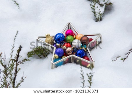 on the snow, Christmas toys in a star-shaped vase. Background: New Year, Christmas, Holiday, Celebration.
