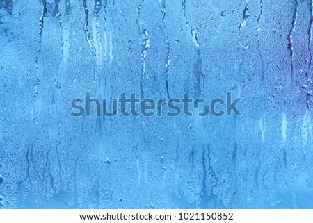 Natural blue water drop background on glass