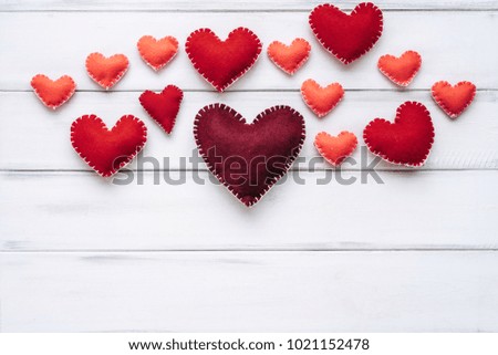 Space for text by Valentine's Day on White wooden background with red hearts, gifts. Flat lay. Top view
