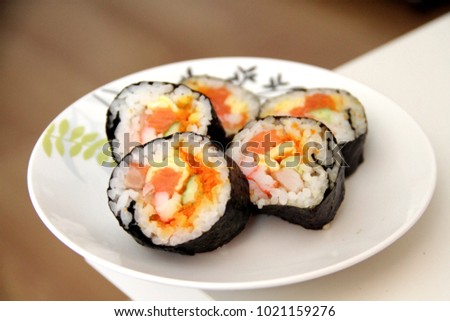 California Roll - California Maki  is Japanese food  in a white plate on a white table.