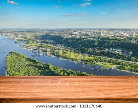 Empty wooden table with blurred background of aerial view of the Volga river and the Nizhny Novgorod city. Can be used for display or montage products