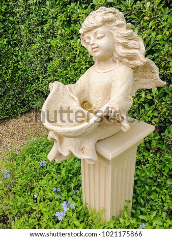 statue of young roman doll  decoration in a garden