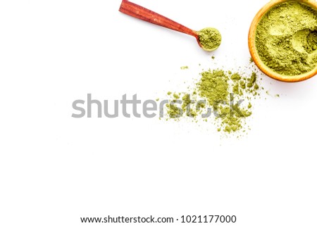 Powdered matcha green tea in bowl on white background top view copy space