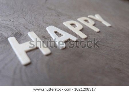 Letters forming word HAPPY on vintage wood table. Happy and inspiration concept.