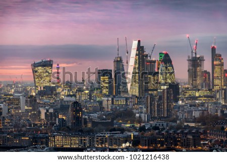The illuminated City of London, financial district, just after sunset