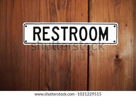Toilet sign,restroom symbol on an old wood door texture background.Easy to use.