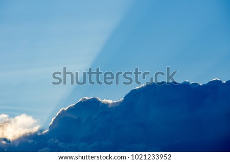 Sunrays above dark clouds