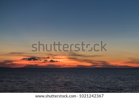 View of tropical beach on the sunset sea background