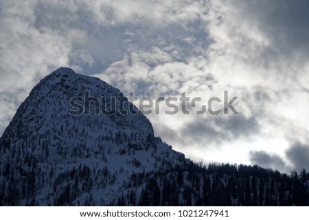 Granite mountains covered with snow and winter forest near Mont Blanc Alpes, Italy.