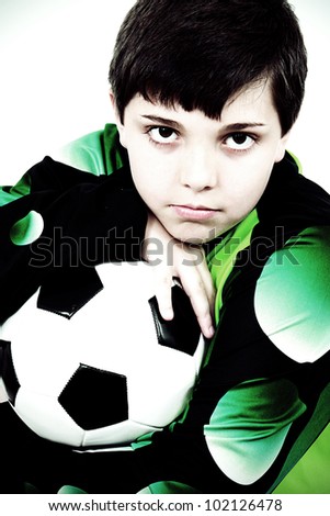 Young soccer player in dark light