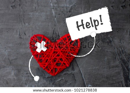 Red heart with a sign asking for help. Theme of medicine, health. Copy space 1