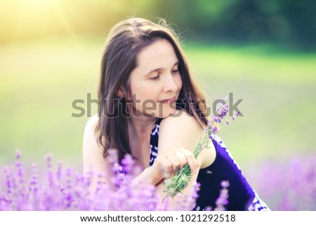 Beautiful girl in lavender field. Happy woman on meadow background. Stunning lavender landscape with lady who enjoy aroma and colors. Charming woman. Best photo for 8 march international womens day