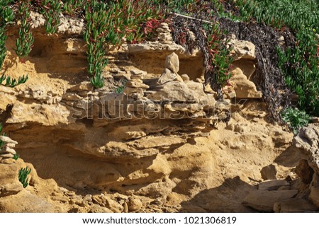 Italy, Sicily, Puntabraccetto beach (Ragusa Province), Mediterranean sea, piled stones on the rocks