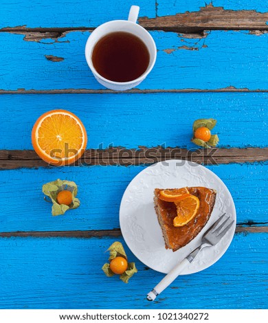 Almond nut cake orange sweet glaze blue wooden table.