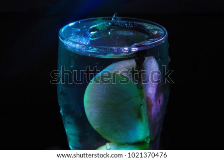 Frozen block in a glass with ice. Around darkness. Very cold photograph.