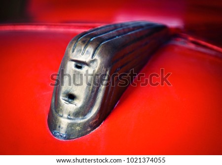 background detail of an ornament on an old red car