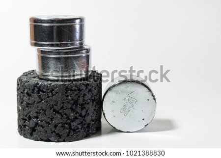 Asphalt sample or specimen with weight on it, representing bearing capacity test for civil engineering Royalty-Free Stock Photo #1021388830
