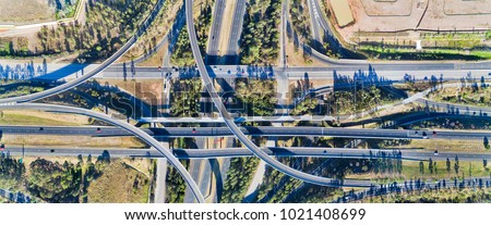 Wide panoramic aerial view on Light Horse intersection in Sydney West between Motorway M4 and Motorway M7 on a bright sunny day with driving traffic. Royalty-Free Stock Photo #1021408699
