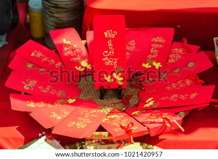 Red envelopes Lunar New Year Calligraphy decorated with text "Merit, fortune, longevity" in Vietnamese means anyone receives money from envelope will be lucky, successful, make a lot of money