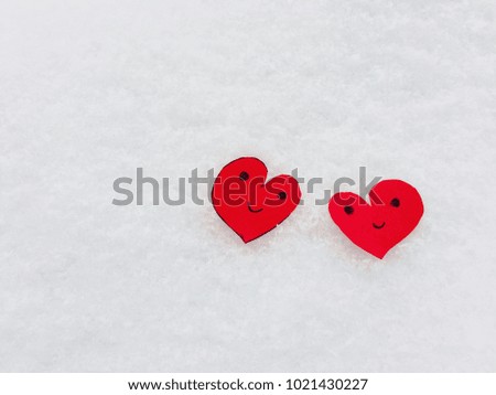 Cut paper in heart shape with drawing smile on snow background. Love and Valentine’s concept with copy space