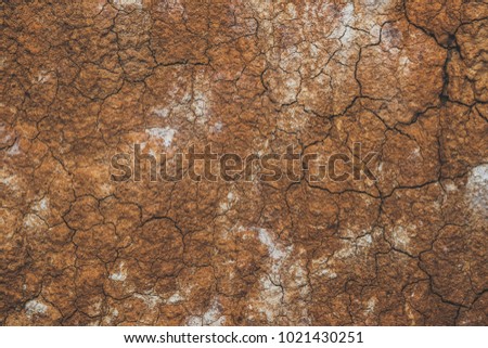 top view cracked  red soil ground Earth for texture background,desert cracks,Dry Orange surface Arid,drought land,Picture of natural disaster. drought land Caused by global warming and deforestation.