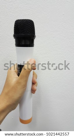 Hand holding microphone on clear background