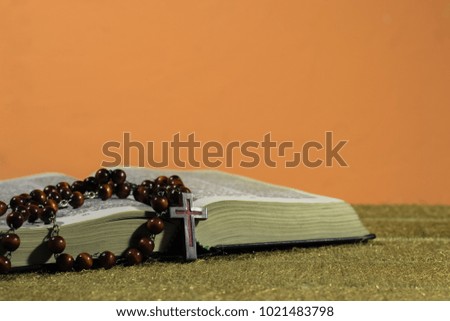 Bible and the crucifix on a Gold table. Beautiful  background.Religion concept.