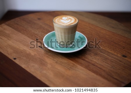 Latte Art Coffee on wooden table vintage style of background