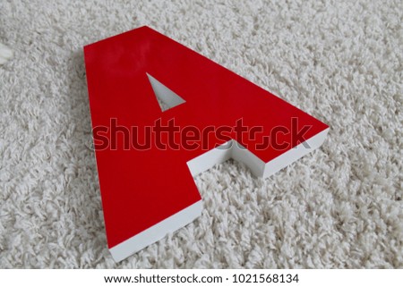 

three-dimensional red letter on a light background
