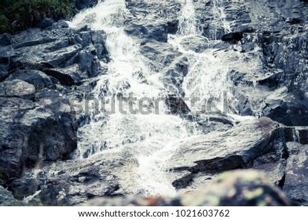 Mountain waterfall on a summer day