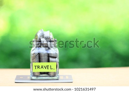 Saving planning for Travel budget of holiday concept,Financial,Stack of coins money in the glass bottle on passport with natural green background