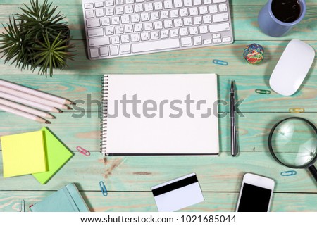 Office desk table with laptop, pen and notebook. Top view with copy space. Online shopping concept.
