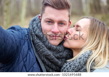 selfie of beautiful young couple outdoors in the cold