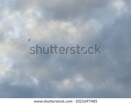 View of an airplane far in the distance in the sky