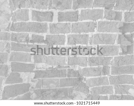         Old white uneven deformed damaged brick wall  