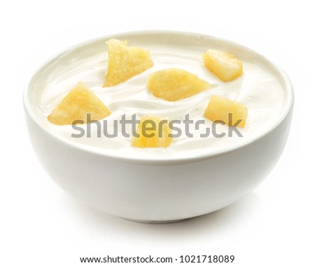 bowl of yogurt with pineapple pieces isolated on white background