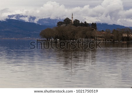 Ioannina lake called "Pamvotis" in a winter cloudy foggy day
