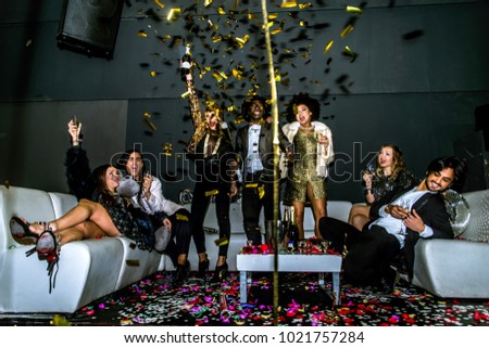 Multi-ethnic group of friends celebrating in a nightclub - Clubbers having party