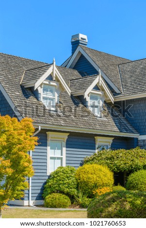 A perfect neighborhood. Houses in suburb at Summer in the north America. Top of a luxury house with nice window over blue sky.
