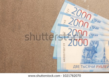 New Russian banknotes denominated in 2000 rubles on a gray background with copy space