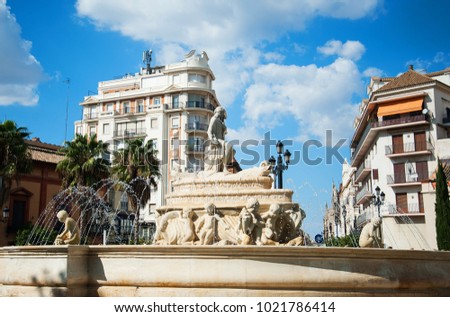 Water fountain on city square in sunny summer day, Sevilla, Spain