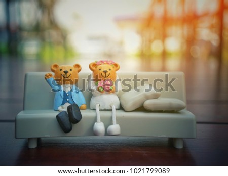 Married couple bear on sofa at garden