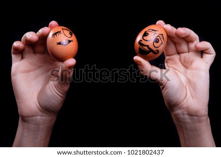 Two eggs with faces painted on them representing Easter