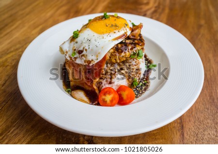 Loco Moco, a traditional Hawaiian dish of ground beef patty and a fried egg on a bed of rice, in gravy Royalty-Free Stock Photo #1021805026