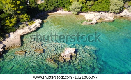 Tropical caribbean island with turquoise and sapphire clear waters and rocky seascape