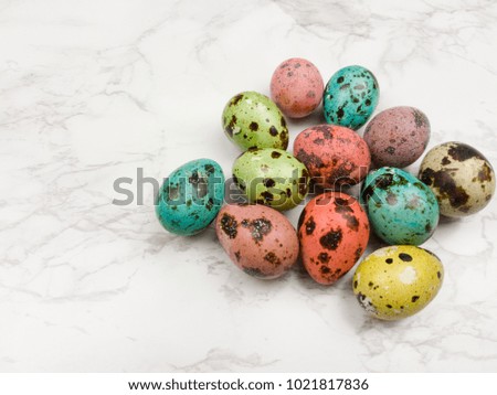 Easter color eggs on marble white background. Close up.