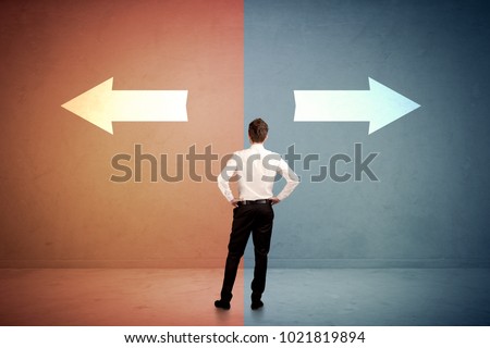 Salesman in doubt standing in front of two arrows on blue and red background concept Royalty-Free Stock Photo #1021819894