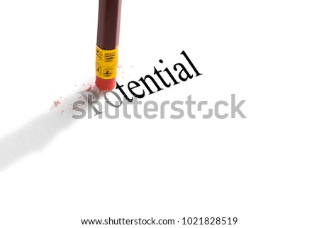 Pencil eraser trying to remove the word 'Potential' on paper.