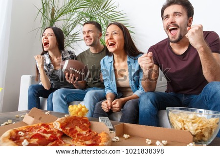 Group of friends sport fans watching rugby match victory Royalty-Free Stock Photo #1021838398