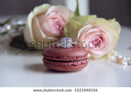 diamond ring on macaron and roses background Royalty-Free Stock Photo #1021848106